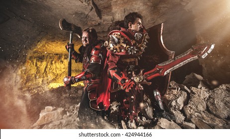 Attack of powerful knights in heavy armor on the dungeon background.
