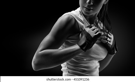 Zwart-wit close-up portret van fitness atletische jonge vrouw in sportkleding met haar goed getrainde lichaam, sixpack, perfecte buikspieren, schouders, biceps, triceps en borst, deltaspier.