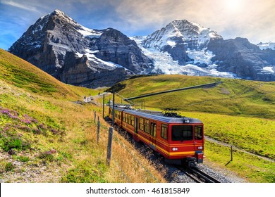 Famous electric red tourist train coming down from the Jungfraujoch station(top of Europe) in Kleine Scheidegg,Bernese Oberland,Switzerland,Europe