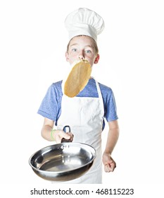 A boy flipping a pancake on white