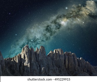 milky way in the sky above the mountain ridge