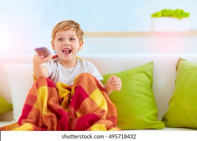 excited boy, kid watching tv at home