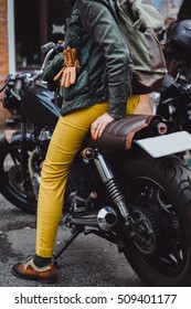 Closeup sexy back in jeans shorts of young pretty blonde woman sitting on vintage custom motorcycle traveling and having fun, hair dresser, crazy woman, posing near ocean, beach bali