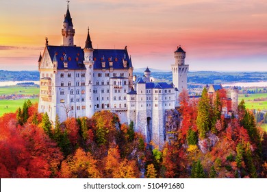 Germany. Famous Neuschwanstein Castle in the background of trees with yellow and green leaves and valley.
