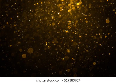 Abstraktní zlatý bokeh s černým pozadím