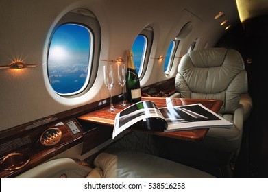 luxe interieur in de moderne zakenjet en zonlicht bij het raam/lucht en wolken door de patrijspoort