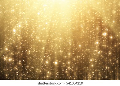Gouden stralen en glitters of glitterlichten. Merry Christmas feestelijke background.defocused cirkel bokeh of deeltjes