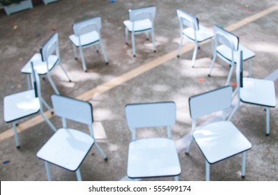 Defocused image of empty chairs. Musical chairs. (Blurred focus)
