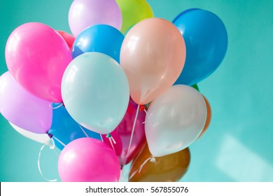 Colorful balloons on the mint background