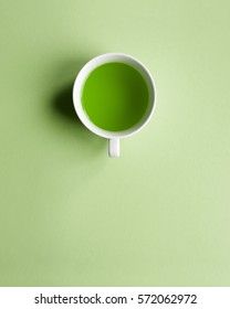 Green tea, green water, white cup. Greenery minimalism art. Health drink. Clean copy space
