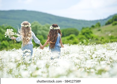 Little girl in a field with flowers 