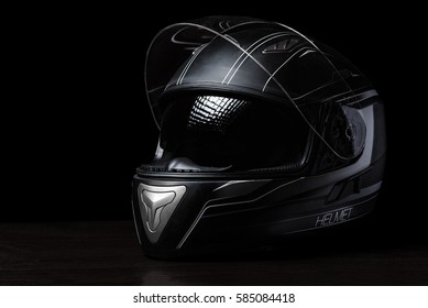 暗い背景に黒いオートバイのヘルメット。