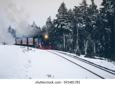 雪に覆われた森を走る歴史的な蒸気機関車