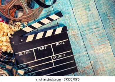 Filmkamera-Tafel, Filmkamera, Rolle und Popcorn auf Holzbrettern. Copyspace für Text