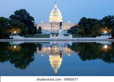The United States Capitol building in Washington DC, USA - after dark with water reflection
