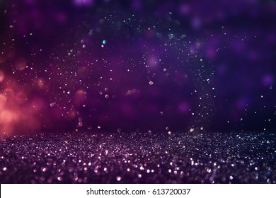glitter vintage lights background. gold, purple and black. de-focused.
