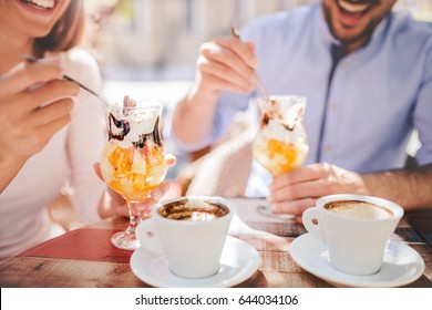 Romantic couple drinking coffee and enjoying in fruit desserts, having fun in the cafe. Dating, love, relationships