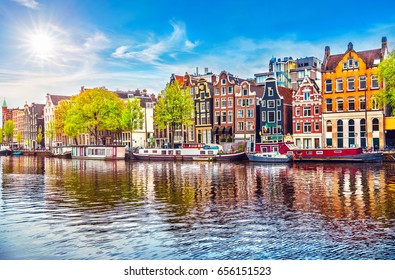 Amsterdam Netherlands dancing houses over river Amstel landmark in old european city spring landscape.