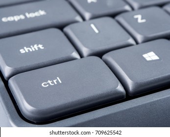Gray keyboard with focus on Strl and Shift buttons and soft focus on back