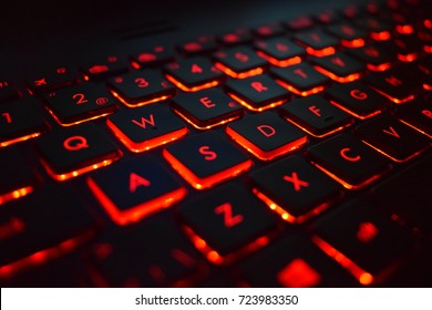 Gaming keyboard on laptop computer with red led lights - Close up - Rog Asus 