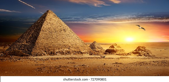 Egyptian pyramids in sand desert and clear sky.