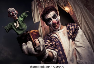 scary clown holding a Jack-in-the-box toy