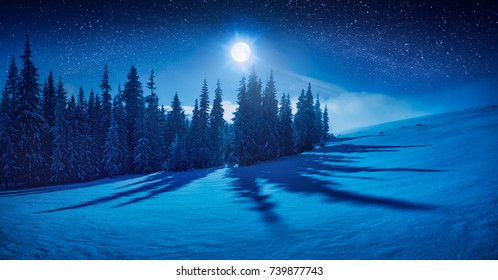 Fairy winternacht in een bergdal met volle maan in een sterrenhemel. Kerststemming.