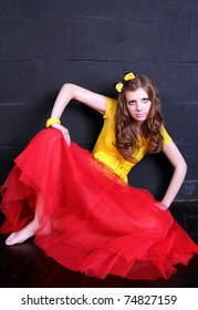 Glamour woman doll near black brick wall