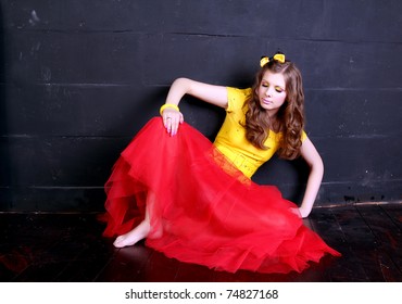 Glamour woman doll near black brick wall