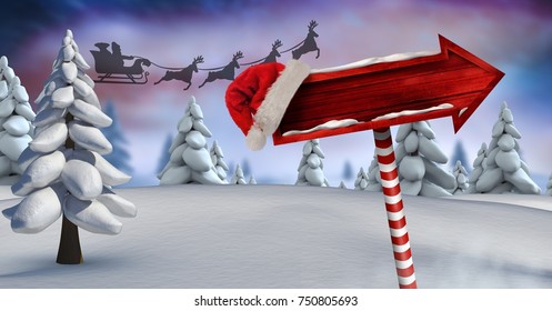 Compuesto digital de cartel de madera en el paisaje de invierno de Navidad y trineo de Papá Noel y renos