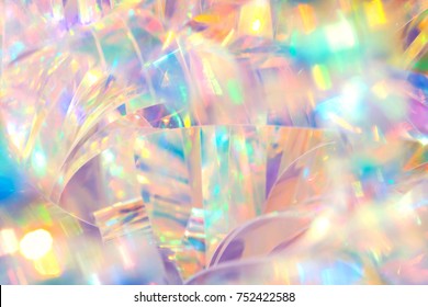 Abstract radiant cheerful disco fun wallpaper image of festive holographic foil ribbon with bright gleaming pastel colored sparkling crystal reflections and blurred bokeh light effect