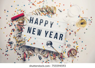 Happy New year displayed on a vintage lightbox with decoration for New Year's Eve, concept image