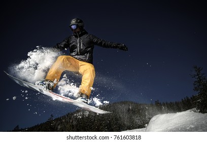 Snowboarder saltando en invierno con nieve, deportes extremos, cuesta abajo, oscuro, snowboard