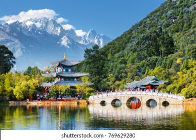 中国雲南省麗江の玉泉公園にある黒龍池にかかる玉龍雪山と蘇翠橋の美しい景色。