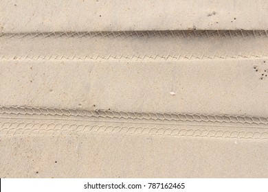 motorcycle tire on sand top view