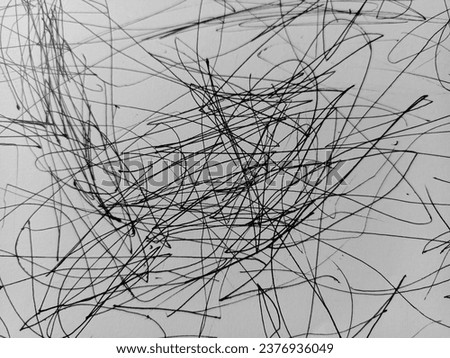 image of a 3 year old child scribbling using a pen on white paper