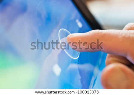 finger touching screen  on tablet-pc with shallow depth of field Royalty-Free Stock Photo #100015373