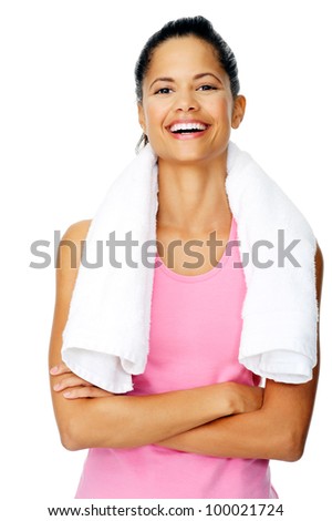 healthy fit woman with gym towel stands with confidence and smiles isolated on white