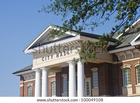 A classic brick town city hall through the trees Royalty-Free Stock Photo #100049108