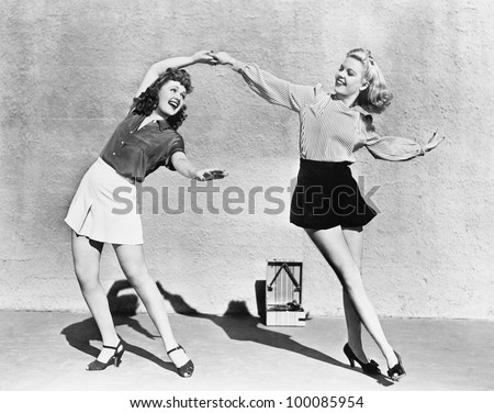 Two women dancing outside Royalty-Free Stock Photo #100085954