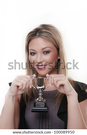 attractive woman holding a trophy in her hands