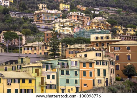 A village with farraginous houses nestles in the hills of  the Ligurian Coast