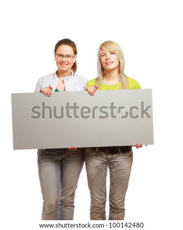 Portrait of two beautiful young women holding blank notecard isolated on white background