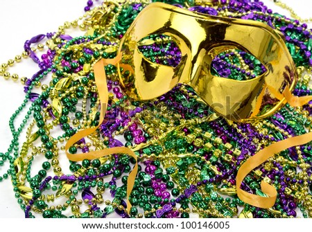 Mardi Gras masquerade mask on a background of colorful Mardi Gras Beads