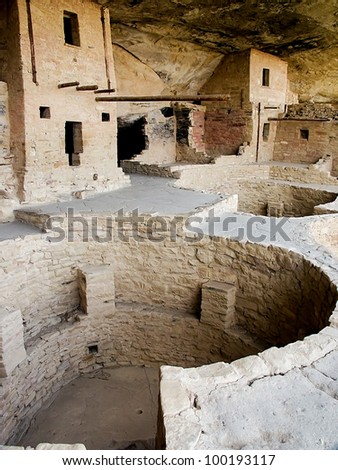 Balcony House ruin at Mesa Verde National Park in the Four Corners area of Colorado showing structures and a round kiva in the foreground.