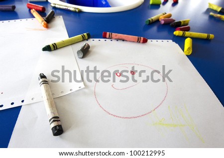 Smiling smile face done by colors, painting and drawing of little child. Concept photo of young artist, art, artwork, creativity and imagination.