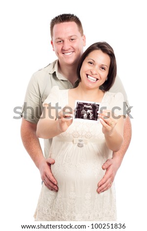 Portrait of happy pregnant woman with her husband showing ultrasound picture of baby, isolated on white background.