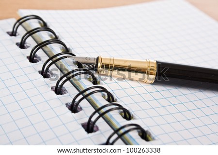opened notebook with pen