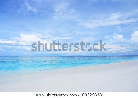 White sand beach and clear blue sea with beautiful sky