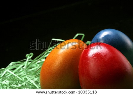 3 eggs are standing on the grass